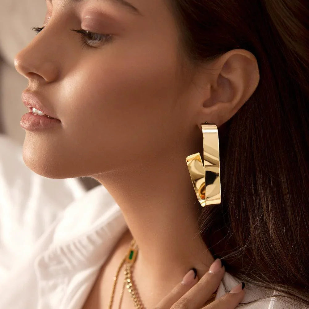 Gold Wavy Metal Oval Hoop Earrings - Jewelry Store by Erik Rayo