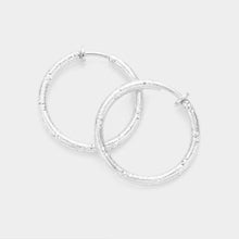 Load image into Gallery viewer, Silver 1.25 Inch Textured Metal Hoop Clip On Earrings
