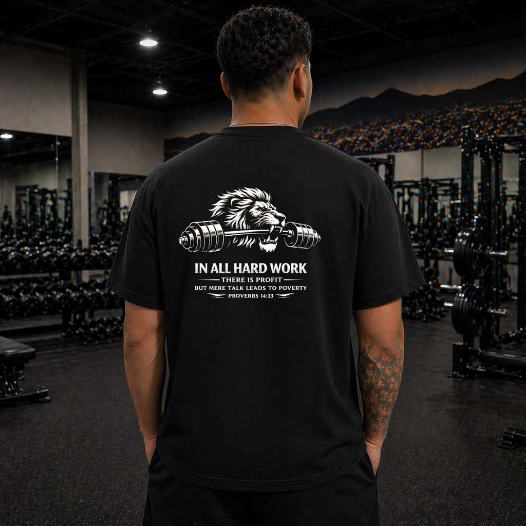 Person wearing a black t-shirt with a lion graphic and text in a gym setting