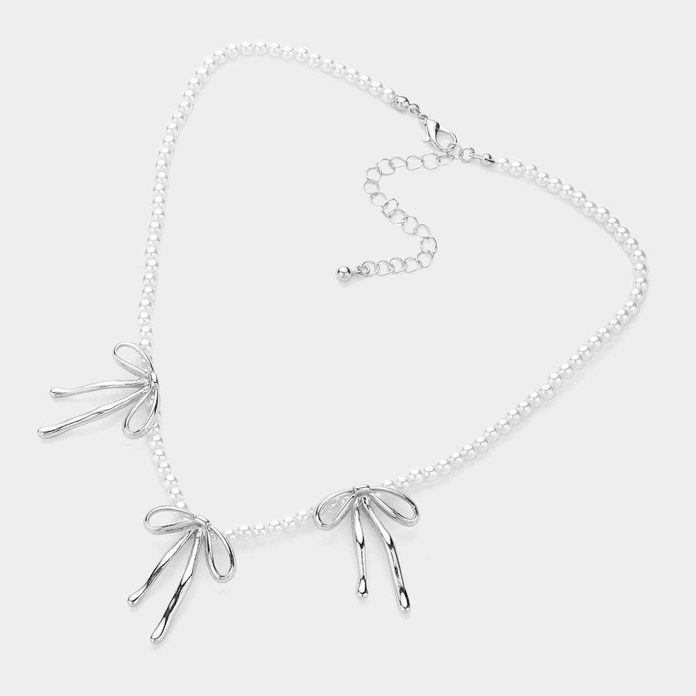 Metal Bow Pendant Station Pearl Necklace - Jewelry Store by Erik Rayo