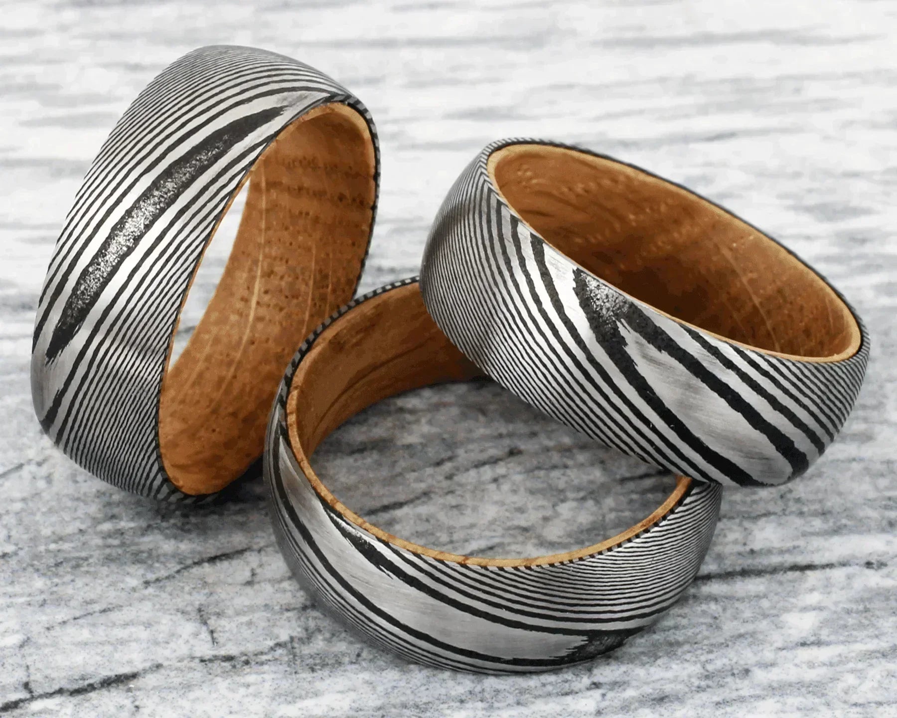 Men’s Black Damascus Steel Wedding Band with Whiskey Barrel Wood Sleeve - Unique Wedding Rings for Men & Women - Jewelry Store by Erik Rayo